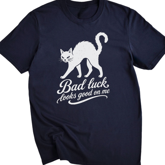 A navy blue short-sleeve t-shirt with a white graphic of a walking cat and the text 'Bad luck looks good on me' printed on the front, displayed against a solid white background.