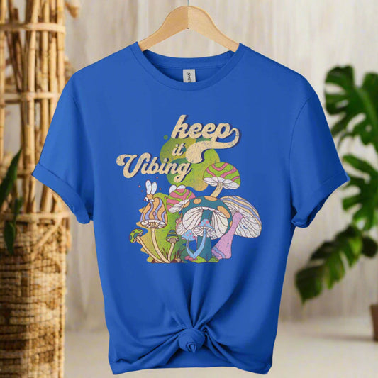 T-shirt color royal blue ,unisex with front design mushroom graphics and keep vibing typography ,retro tees