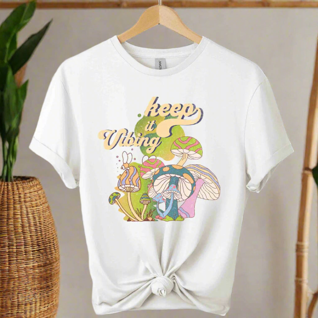 T-shirt color white,unisex with front design mushroom graphics and keep vibing typography ,retro tees