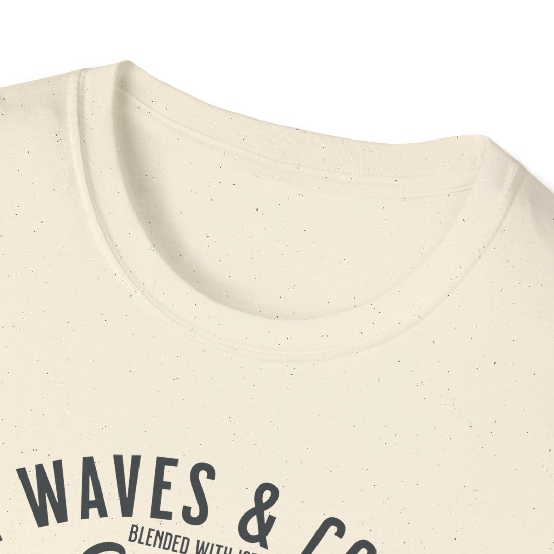 Close-up of a beige t-shirt with 'WAVES & CO' text on a white background