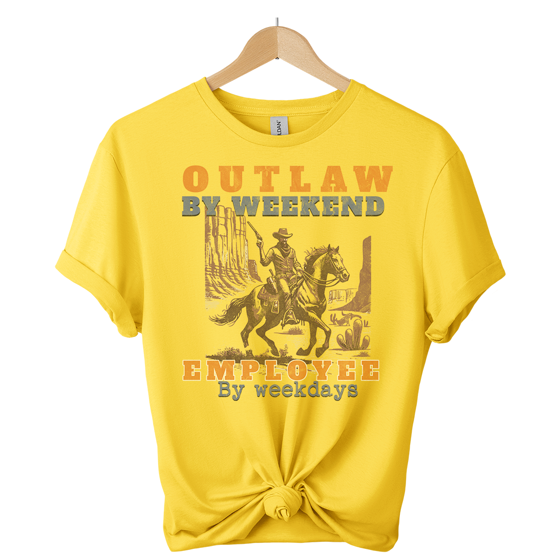 Yellow t-shirt with a graphic of a person on a horse and text, hanging on a wooden hanger.