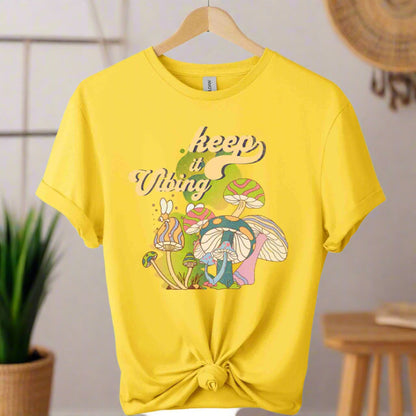 T-shirt color daisy ,unisex with front design mushroom graphics and keep vibing typography ,retro tees 