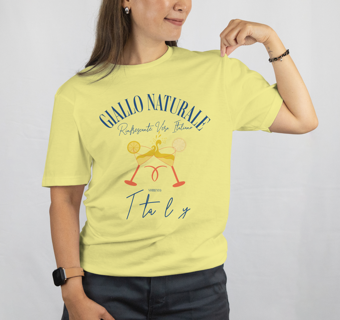 Person wearing a yellow t-shirt with text and graphics on a plain background