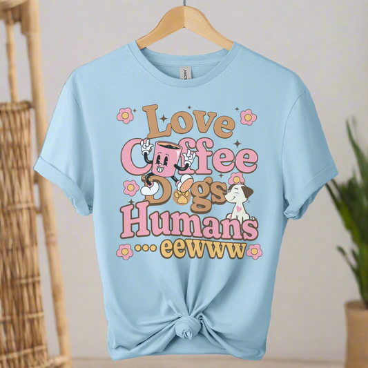 Light blue t-shirt with colorful text and dog illustrations coffee on a hanger