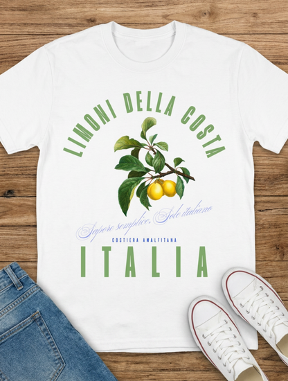 White t-shirt with 'Limonelli della costa Italia' design on a wooden surface with jeans and shoes.