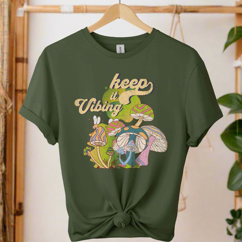 T-shirt color military green,unisex with front design mushroom graphics and keep vibing typography ,retro tees 