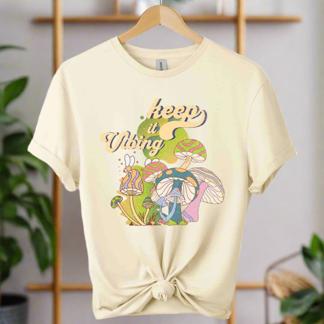 T-shirt color natural,unisex with front design mushroom graphics and keep vibing typography ,retro tees 