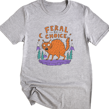 A sport gray short-sleeve t-shirt with a graphic print of an orange werewolf standing on a purple rock with pine trees and the text 'FERAL BY CHOICE'.neilikha