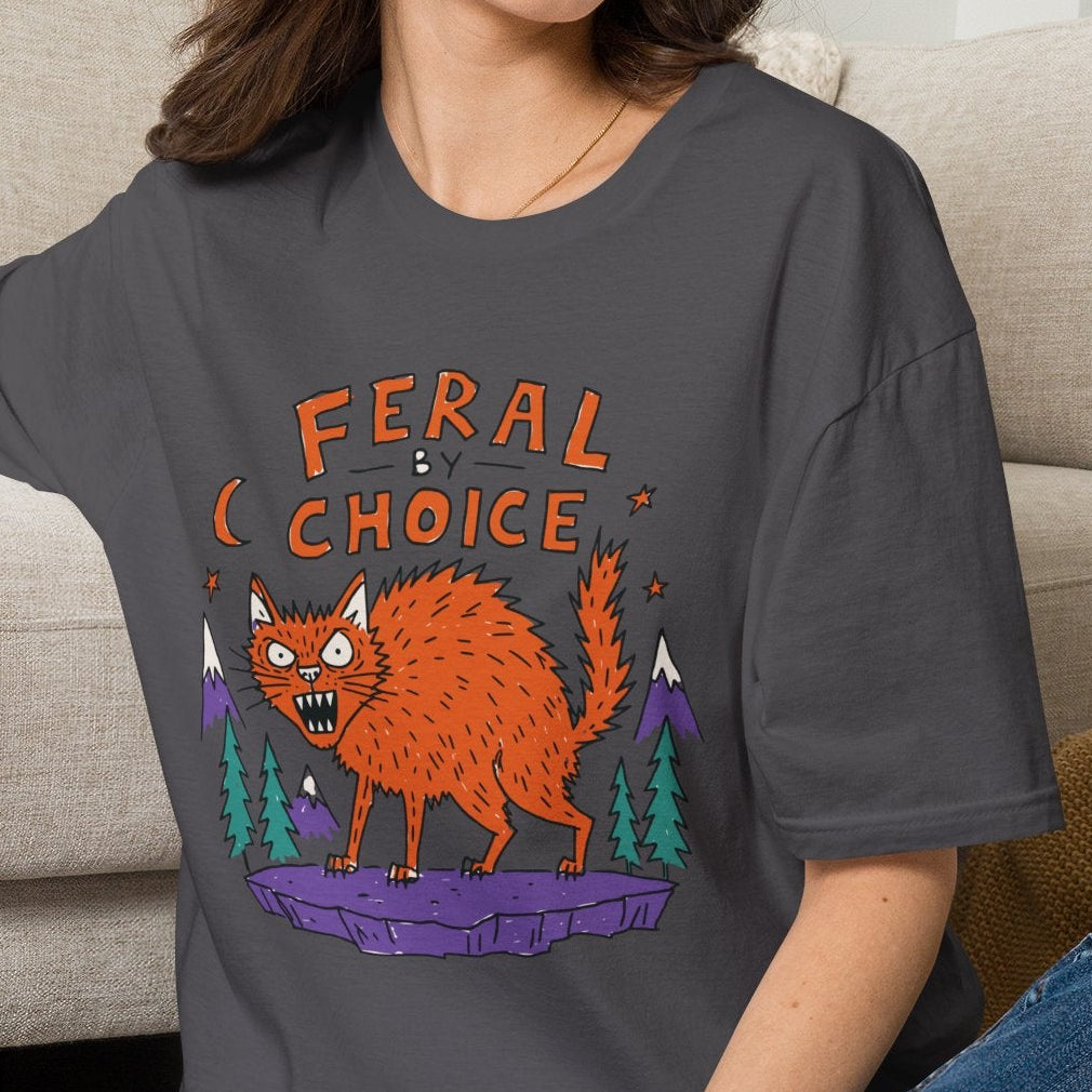 Women wearing a charcoal t-shirt with cat graphic and typography ferral by choice neilikha
