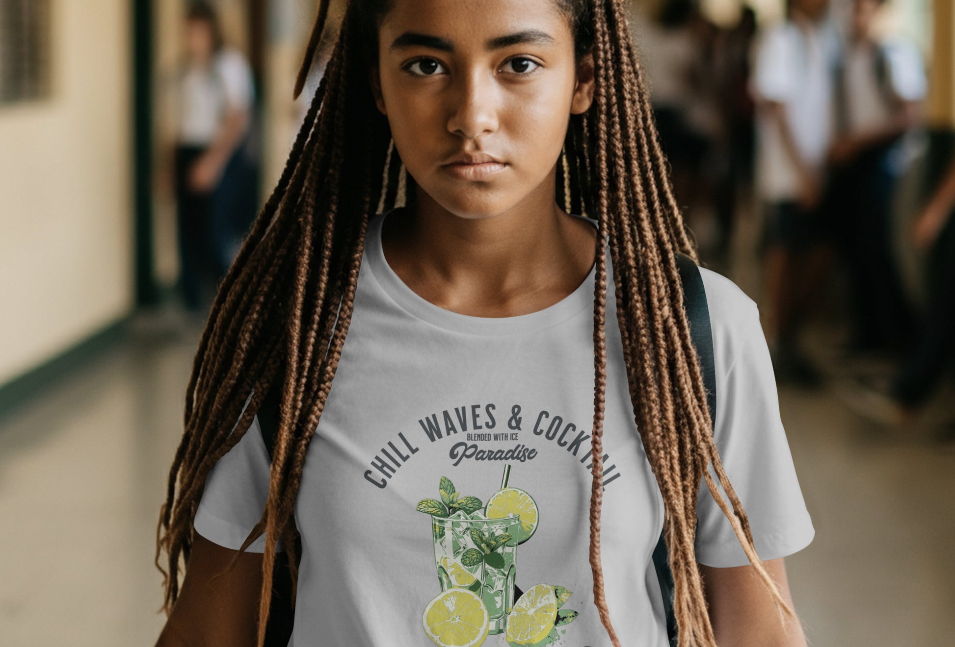 Person with dreadlocks wearing a t-shirt in a school hallway
