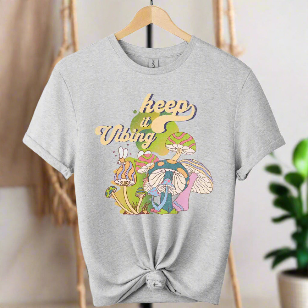 T-shirt color sports grey ,unisex with front design mushroom graphics and keep vibing typography ,retro tees 