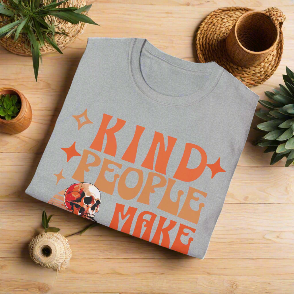 Folded gray t-shirt with orange text 'KIND PEOPLE MAKE' on a white background