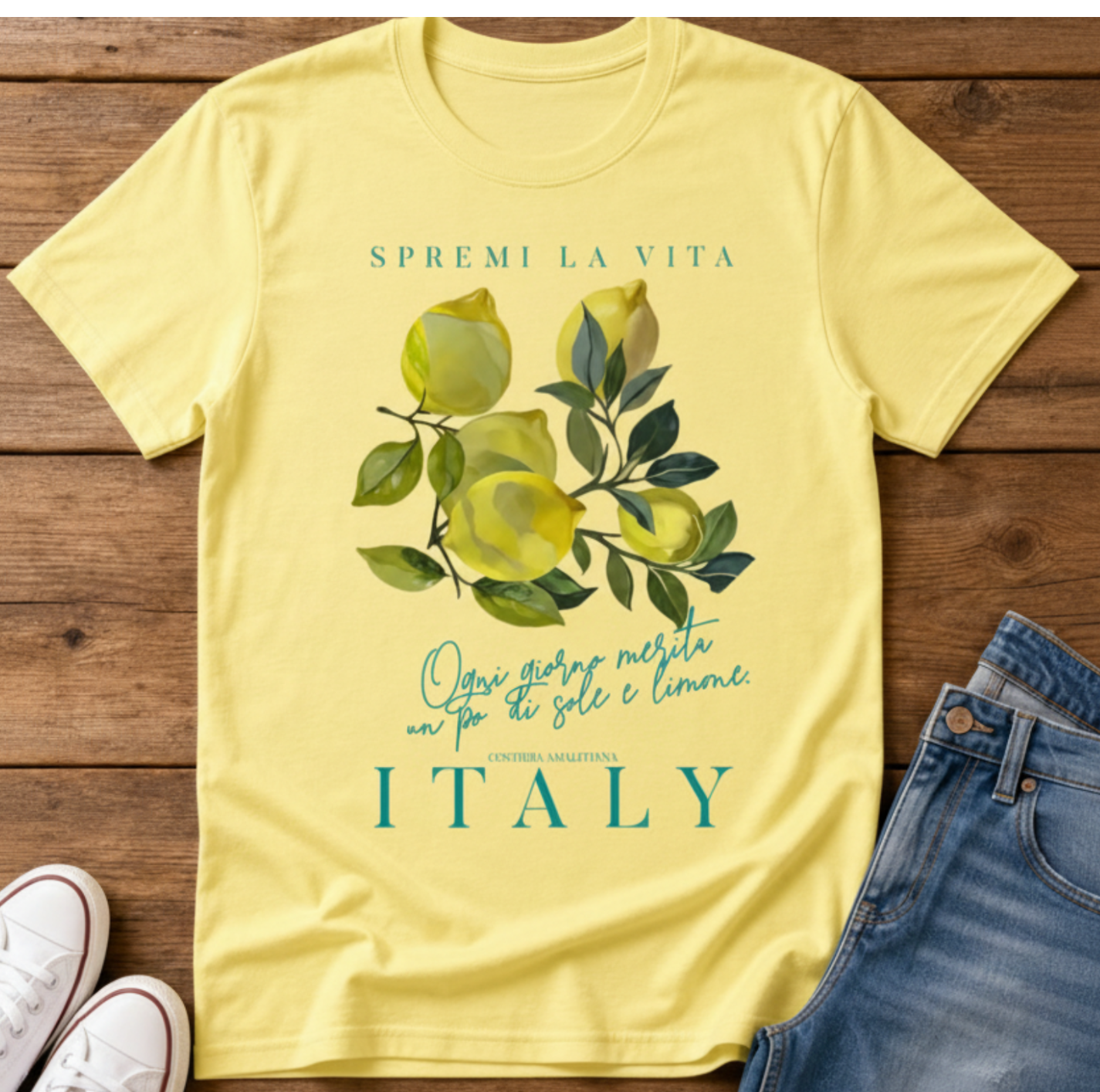cornsilk flatlay t-shirt with a watercolor Mediterranean lemon graphic and teal Italian text reading Spremi La Vita Italy