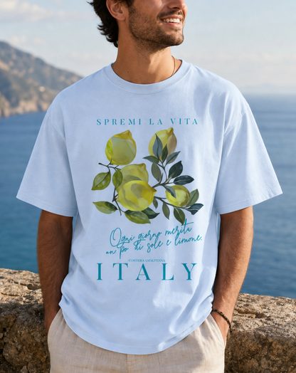 Light blue t-shirt with a watercolor Mediterranean lemon graphic and teal Italian text reading Spremi La Vita Italy
