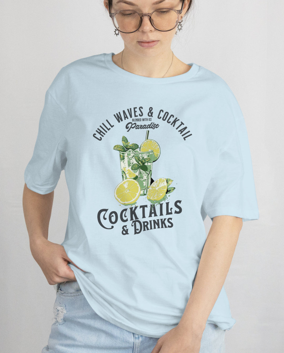 Person wearing a light blue t-shirt with graphics and text on a plain background