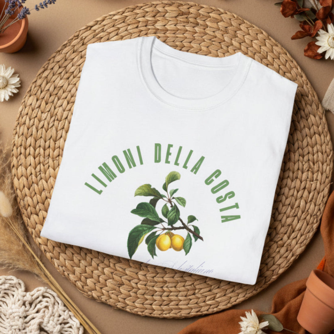 folded white t-shirt with a vintage Italian botanical lemon branch graphic and green Limoni Della Costa Italia text