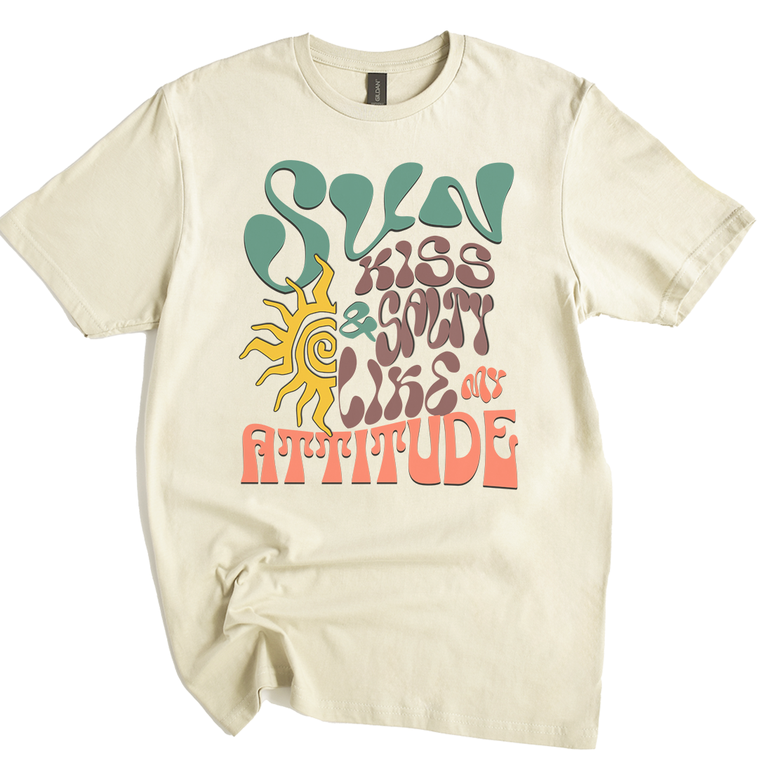Natura t-shirt featuring a wavy 70s groovy font graphic reading Sun Kissed and Salty Like My Attitude with a sun drawing 