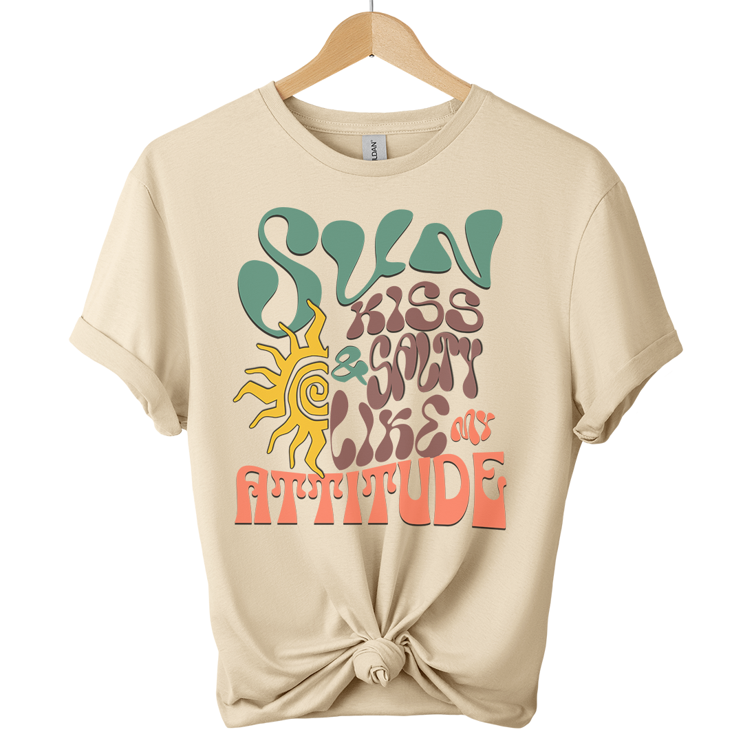Sand t-shirt featuring a wavy 70s groovy font graphic reading Sun Kissed and Salty Like My Attitude with a sun drawing