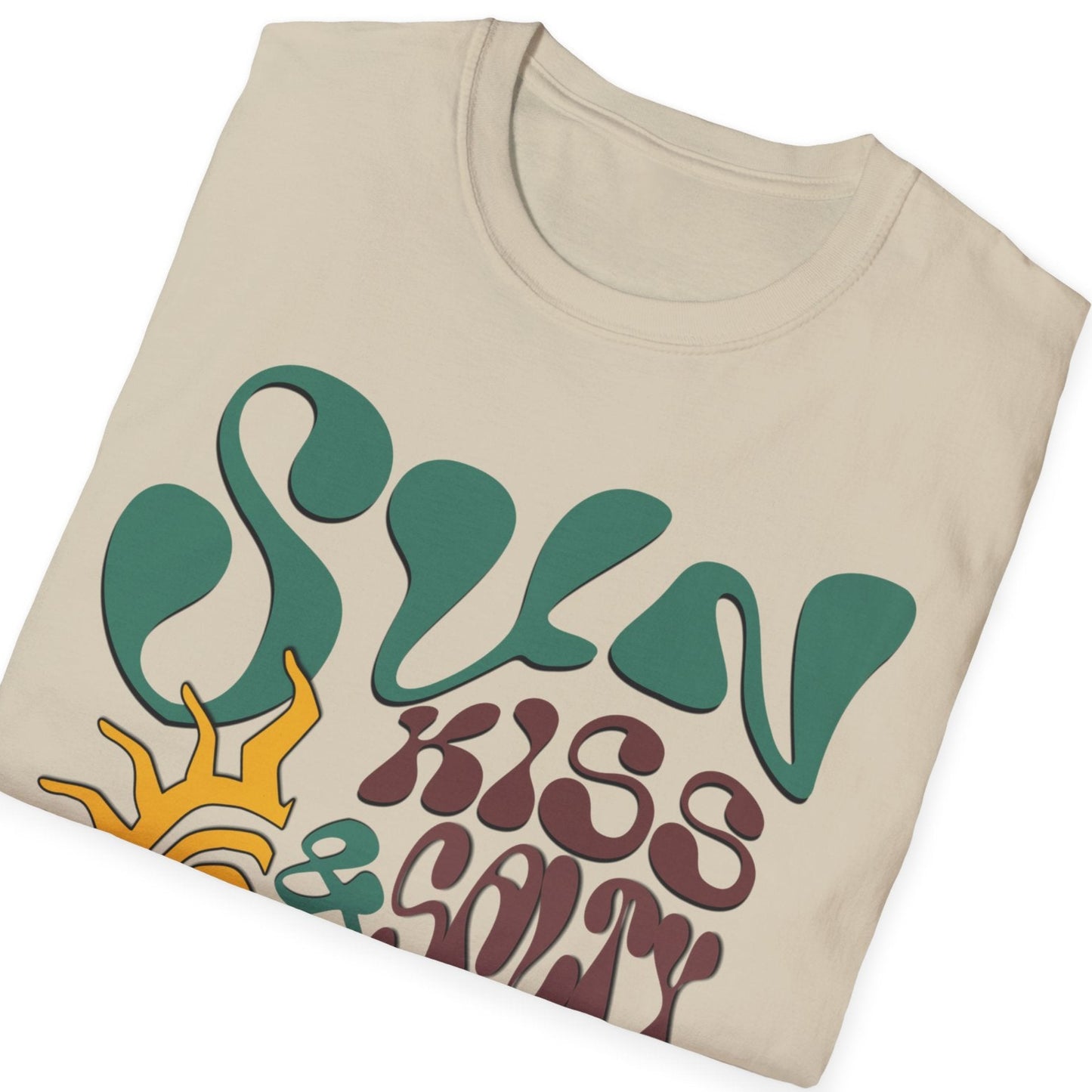 folded sand t-shirt featuring a wavy 70s groovy font graphic reading Sun Kissed and Salty Like My Attitude with a sun drawing